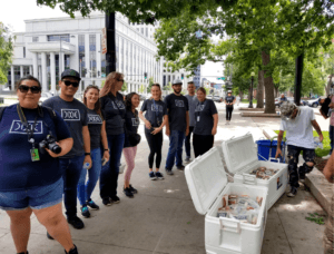 Dixie team passes out sandwiches and cold water at Civic Center Park