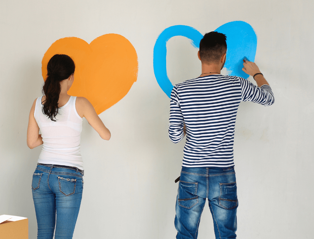 Couple Painting Hearts on Wall